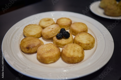 Fried potato rounds with caviar on a white plate can elevate your appetizer selection