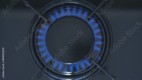 Kitchen burner turning on.Stove top burner igniting into a blue cooking flame.  Natural gas inflammation, close up, slow motion.
 photo