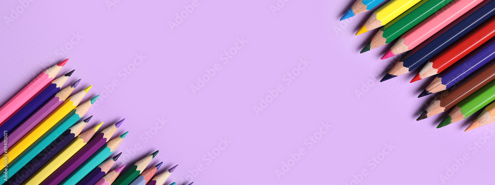Fototapeta premium Different pencils on purple background, closeup