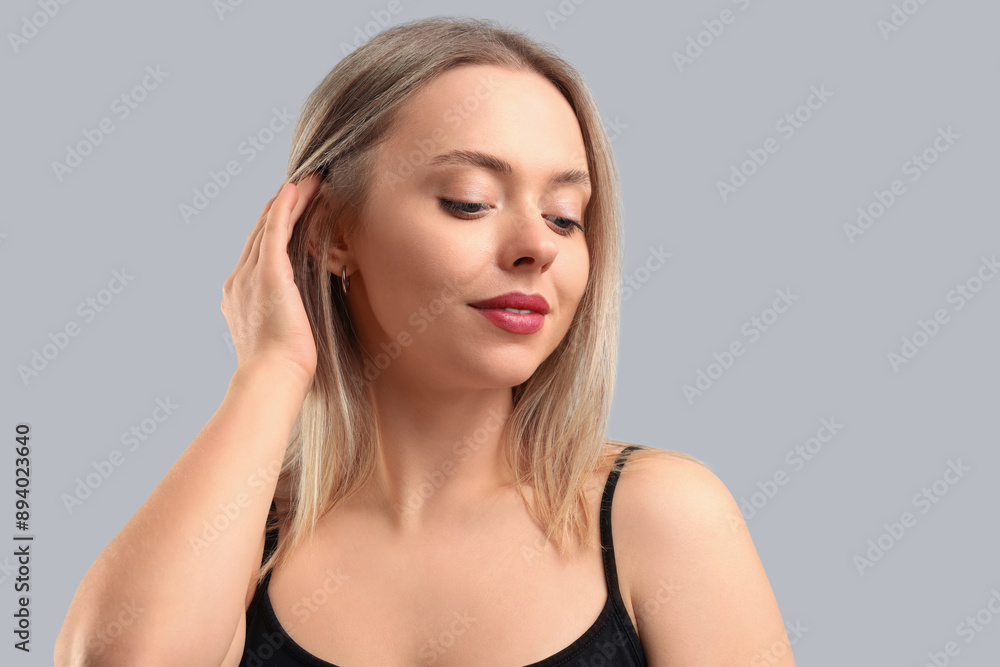 Pretty young woman on grey background. Skin care concept Pretty young woman on grey background. Skin care concept