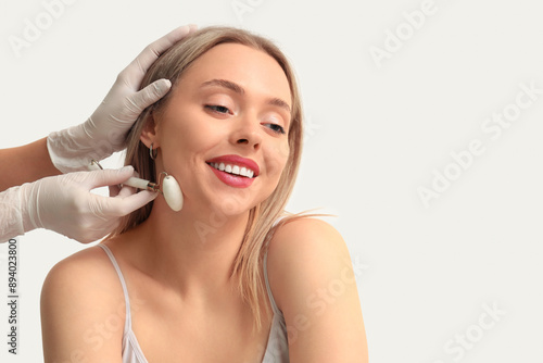 Young woman receiving facia...