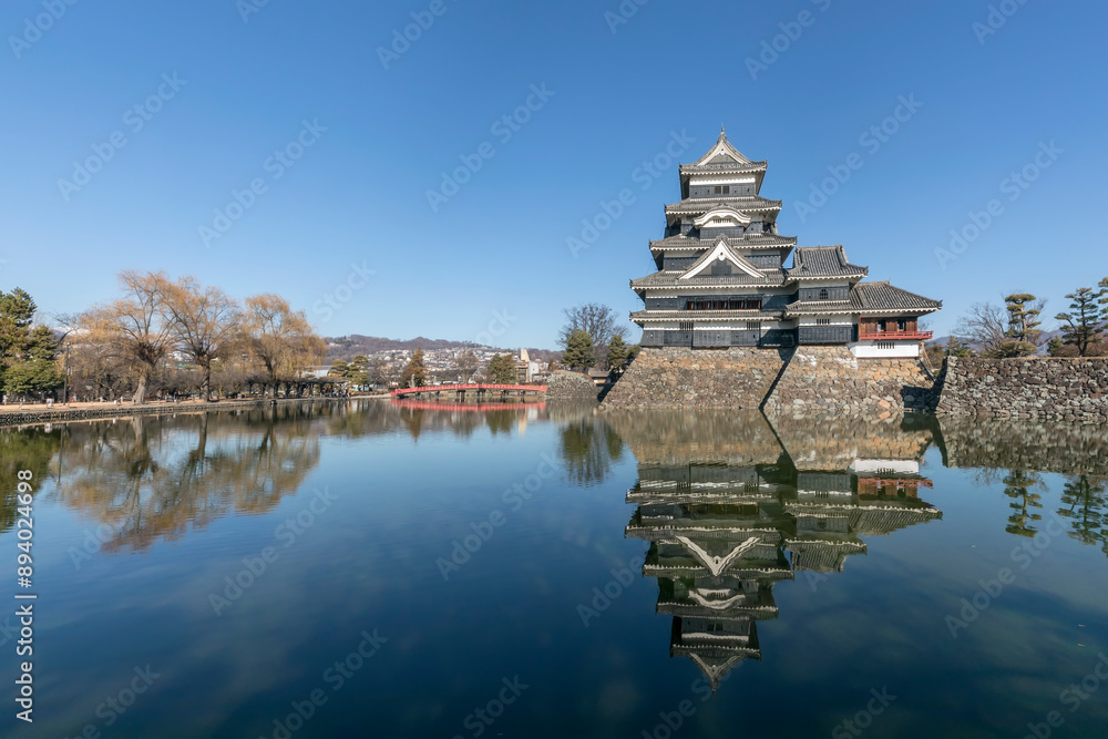 Matsumoto, Japan - December 25, 2023: Matsumoto Castle, view with reflection. One of Japan's premier historic castles Matsumoto, Japan - December 25, 2023: Matsumoto Castle, view with reflection. One of Japan's premier historic castles