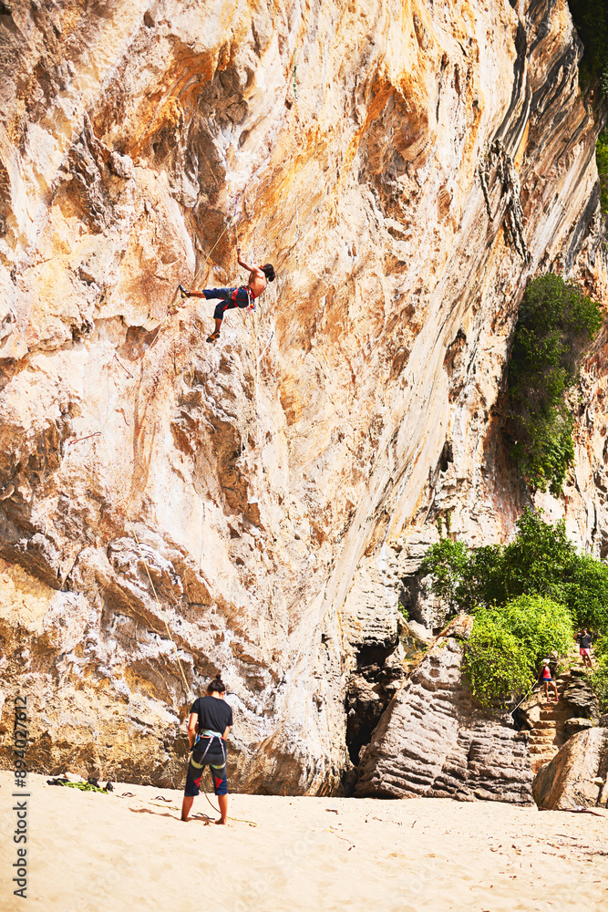 Travel, rock climbing and people with rope by cliff for adventure, adrenaline or fitness challenge. Extreme sports, exercise and man with instructor for harness gear for mountain activity on holiday. Travel, rock climbing and people with rope by cliff for adventure, adrenaline or fitness challenge. Extreme sports, exercise and man with instructor for harness gear for mountain activity on holiday.