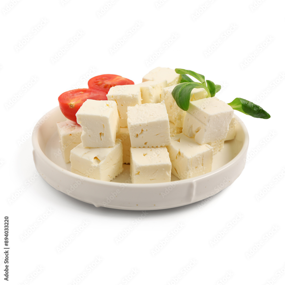 Plate with tasty cut feta cheese, tomatoes and salad leaves on white background Plate with tasty cut feta cheese, tomatoes and salad leaves on white background