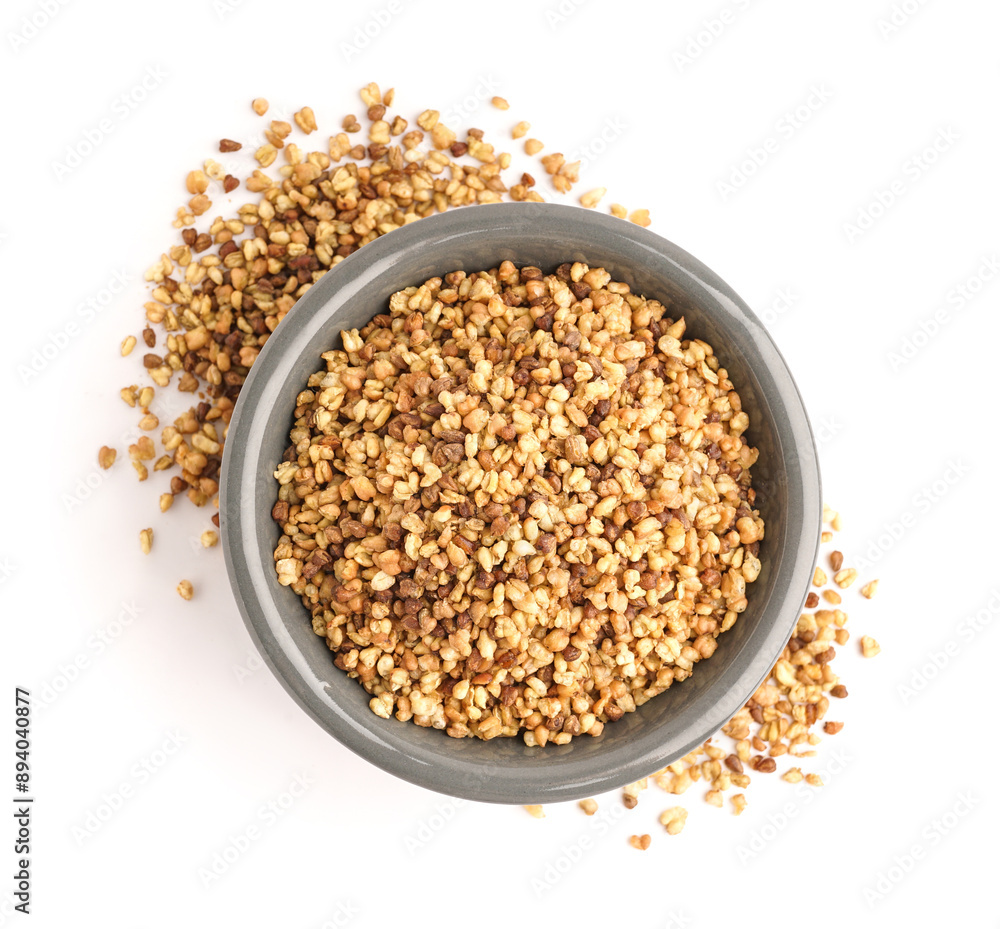Bowl with raw buckwheat grains on white background Bowl with raw buckwheat grains on white background