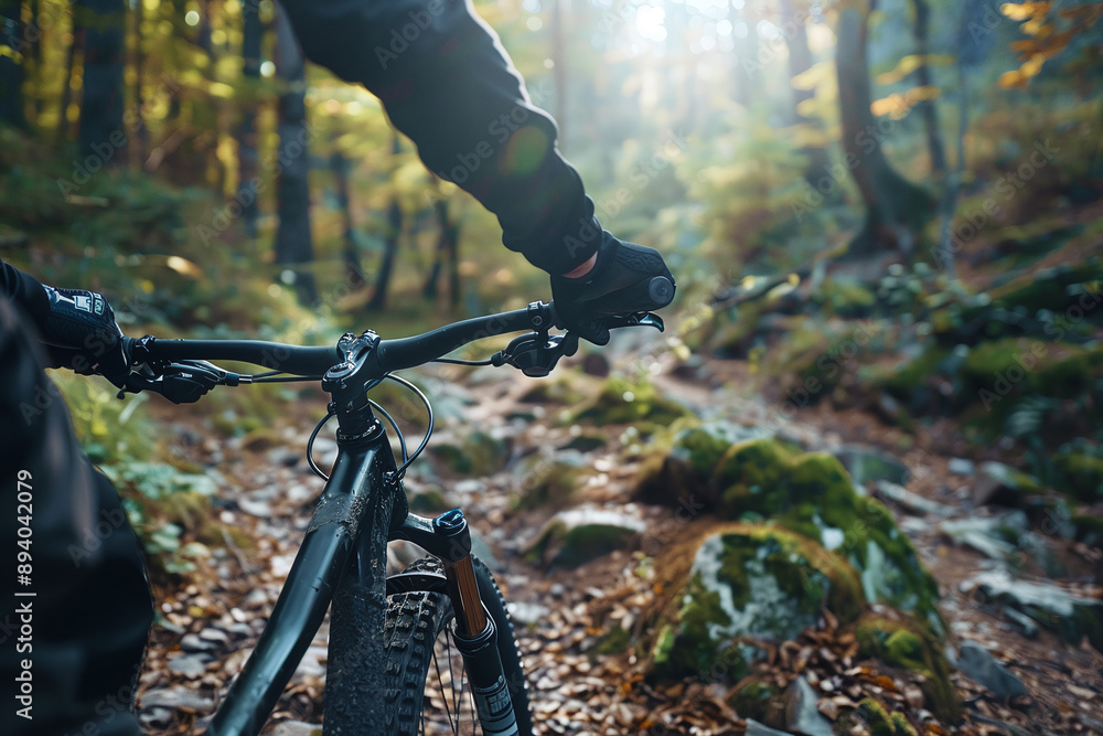 Mountain Biking: close up of a mountain biker navigating a rugged trail through the forest. Mountain Biking: close up of a mountain biker navigating a rugged trail through the forest.