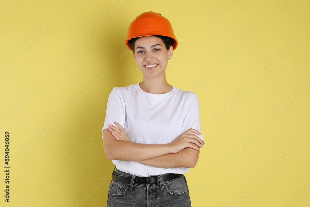 Engineer in hard hat on yellow background Engineer in hard hat on yellow background