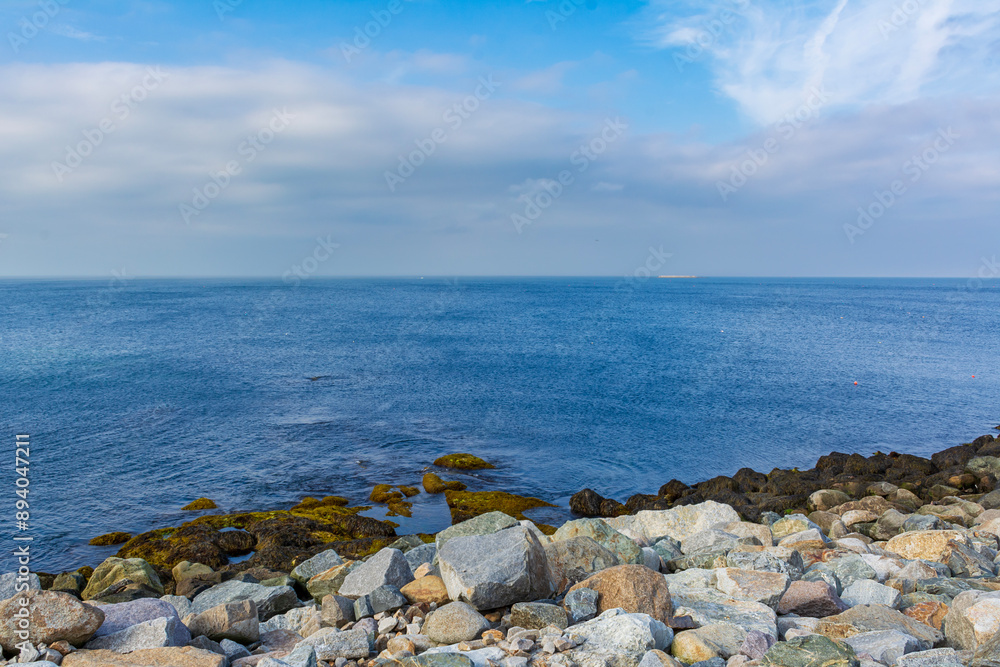 Serene seascape with calm waters, beautiful sky and rocky shoreline, Rockport, Massachusetts, USA Serene seascape with calm waters, beautiful sky and rocky shoreline, Rockport, Massachusetts, USA