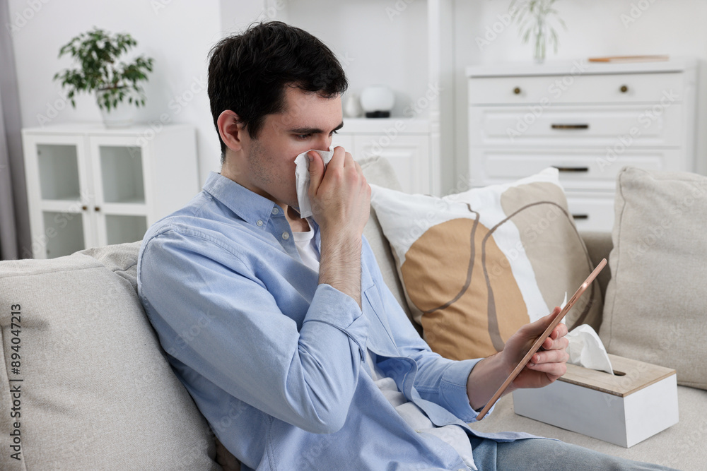 Sick man having online consultation with doctor via tablet at home Sick man having online consultation with doctor via tablet at home