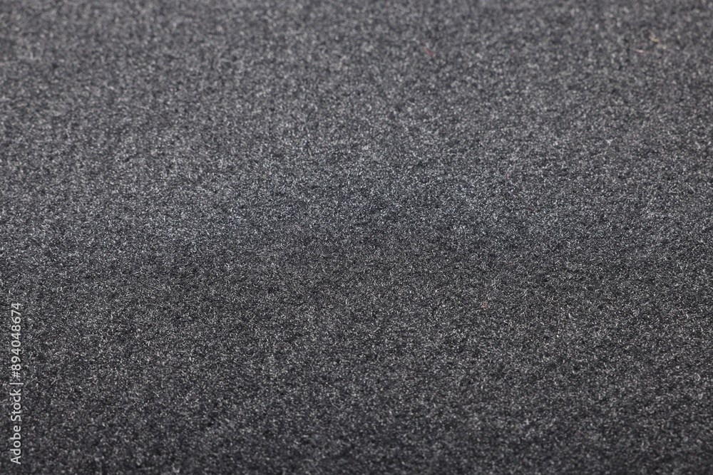 Black car mat as background, closeup view