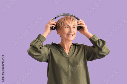 Mature woman putting headph...