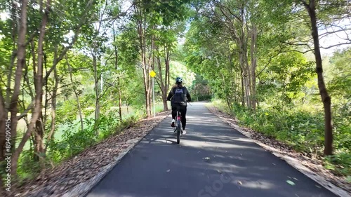 Women rides along a new eco-tourism scenic rail corridor trail winding through the Australian countryside photo