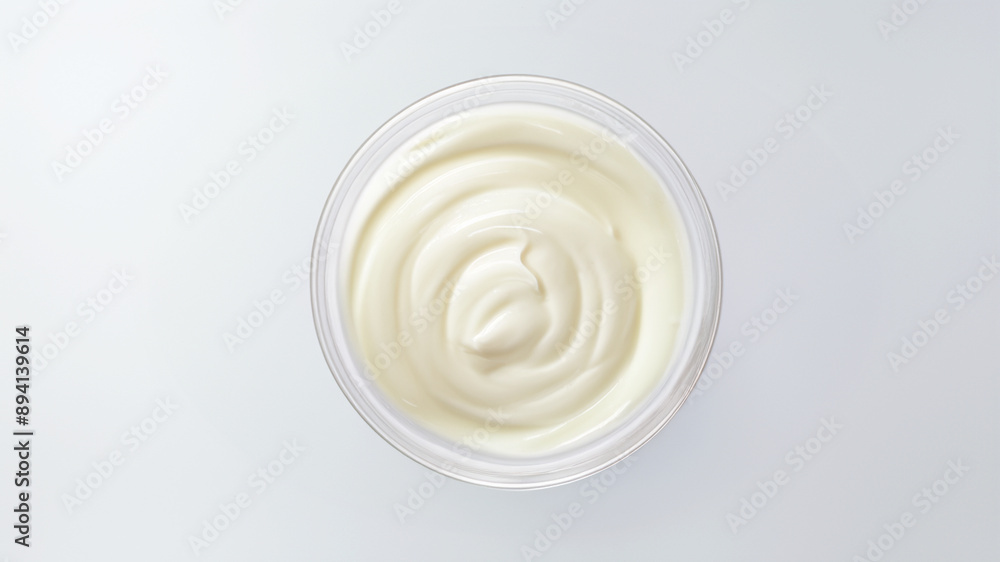 Smooth and creamy whipped cream in a clear glass bowl on a white plate, perfect for topping desserts and beverages, showcasing the light and airy texture of freshly whipped cream Smooth and creamy whipped cream in a clear glass bowl on a white plate, perfect for topping desserts and beverages, showcasing the light and airy texture of freshly whipped cream