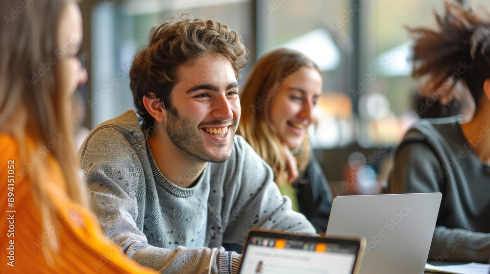 Group of smiling students studying and collaborating on laptops in a bright, modern library or co-working space. Group of smiling students studying and collaborating on laptops in a bright, modern library or co-working space.