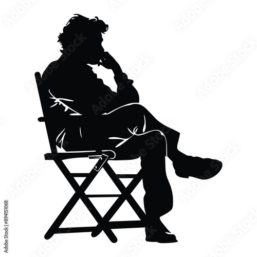 Silhouette of a man sitting on a director's chair