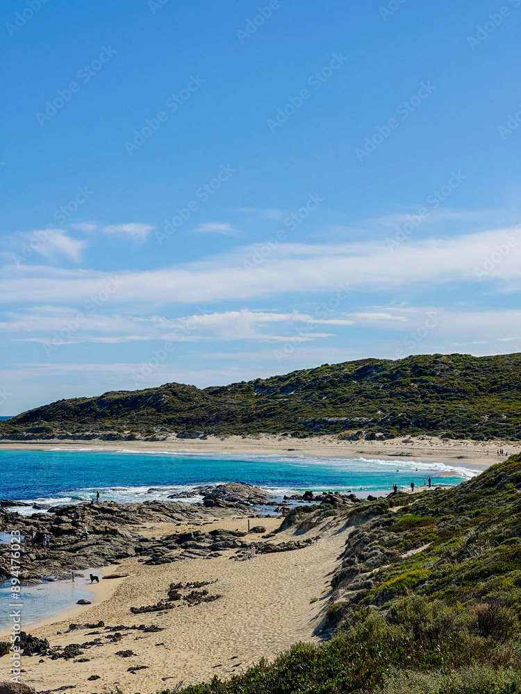 Fototapeta premium Pristine Beach with Clear Waters and Rolling Hills
