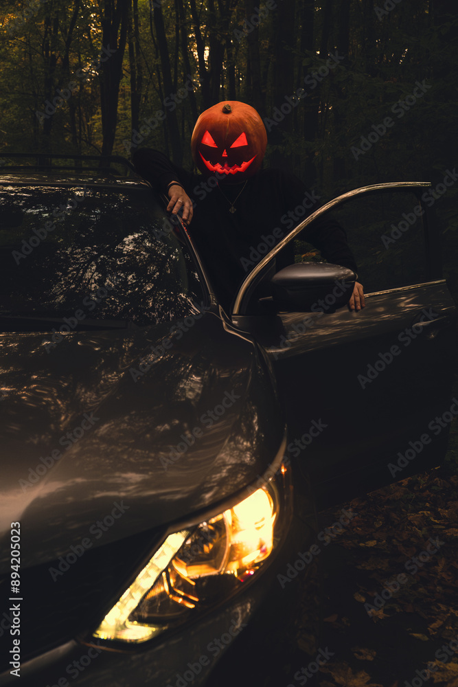 halloween concept man with pumpkin head in suv car