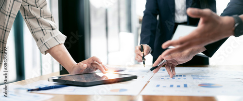 Cropped shot of diverse coworkers working together in boardroom, brainstorming, discussing and analyzing business strategy. photo