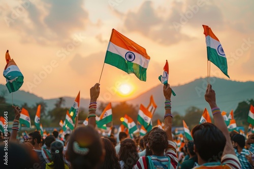 Celebration with Indian flags at sunset with a crowd gathered outdoors. photo