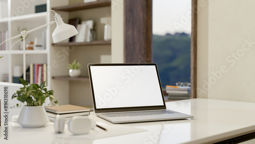 Wallpaper Mural A close-up image of a laptop computer with a white-screen mockup on a white table in a modern room. Torontodigital.ca