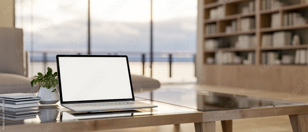 Fototapeta premium A laptop computer mockup on a modern coffee table in a contemporary luxurious living room.