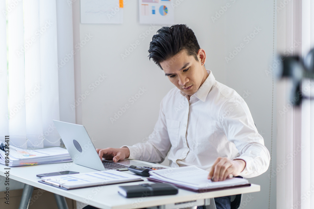 Asian Business man working with laptop. Young business man thinking Concentrated at work. Asian Business man working with laptop. Young business man thinking Concentrated at work.