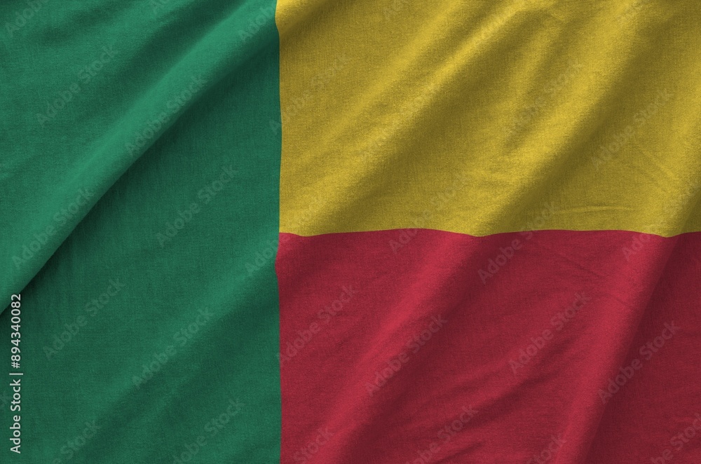Benin flag depicted on folded wavy fabric of old cloth close up Benin flag depicted on folded wavy fabric of old cloth close up