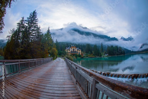 Landscape of Lake Dobbiaco or Toblacher See in the Dolomites. The magnificent reflection of the mountains in the waters of the lake. Pusteria Valley, photo