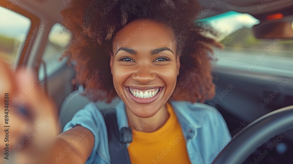 A happy woman with curly hair, sitting in the driver's seat of a vehicle, smiling broadly. A happy woman with curly hair, sitting in the driver's seat of a vehicle, smiling broadly.