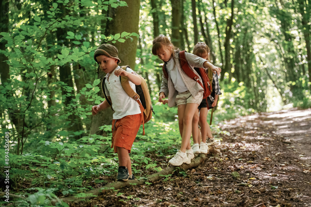 Adventure time. Kids in forest at summer daytime together Adventure time. Kids in forest at summer daytime together