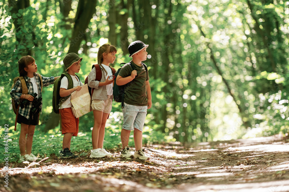 Going to the side. Kids in forest at summer daytime together Going to the side. Kids in forest at summer daytime together