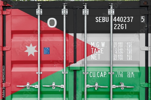 Jordan flag depicted on metal doors of shipping cargo container outdoors in docks area close up photo