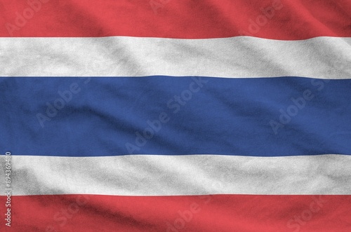 Thailand flag depicted on folded wavy fabric of old cloth close up