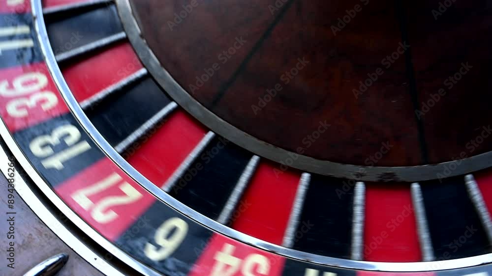 A close-up view of an old roulette wheel spinning, showcasing its classic design and the thrill of the game A close-up view of an old roulette wheel spinning, showcasing its classic design and the thrill of the game