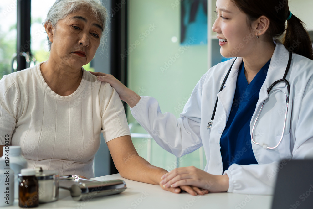 Friendly female doctor hands holding patient hand sitting at the desk for encouragement, empathy, cheering and support while medical examination.