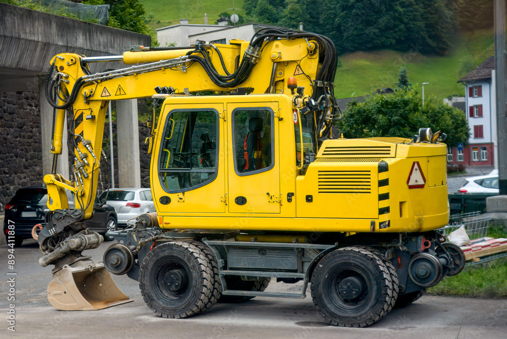 yellow excavator in a construction site in the mountains