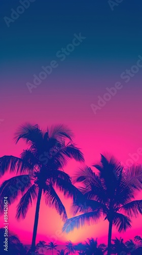 Sunset with palm trees silhouetted against pink sky.