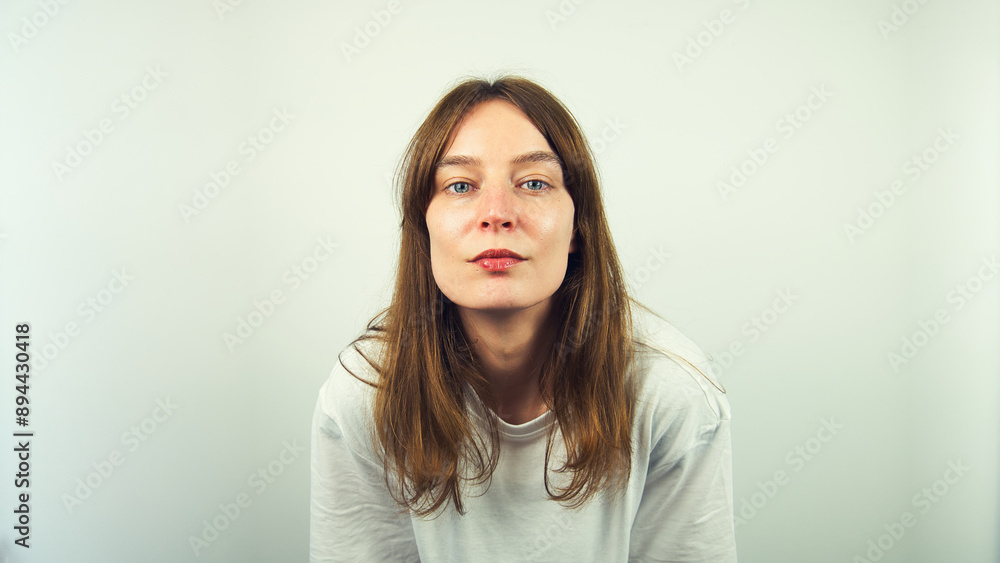 Portrait of beautiful Caucasian young female model with blue eyes and white shirt isolated on white background, copy space area