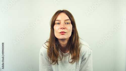 Obraz na płótnie Portrait of beautiful Caucasian young female model with blue eyes and white shirt isolated on white background, copy space area w salonie