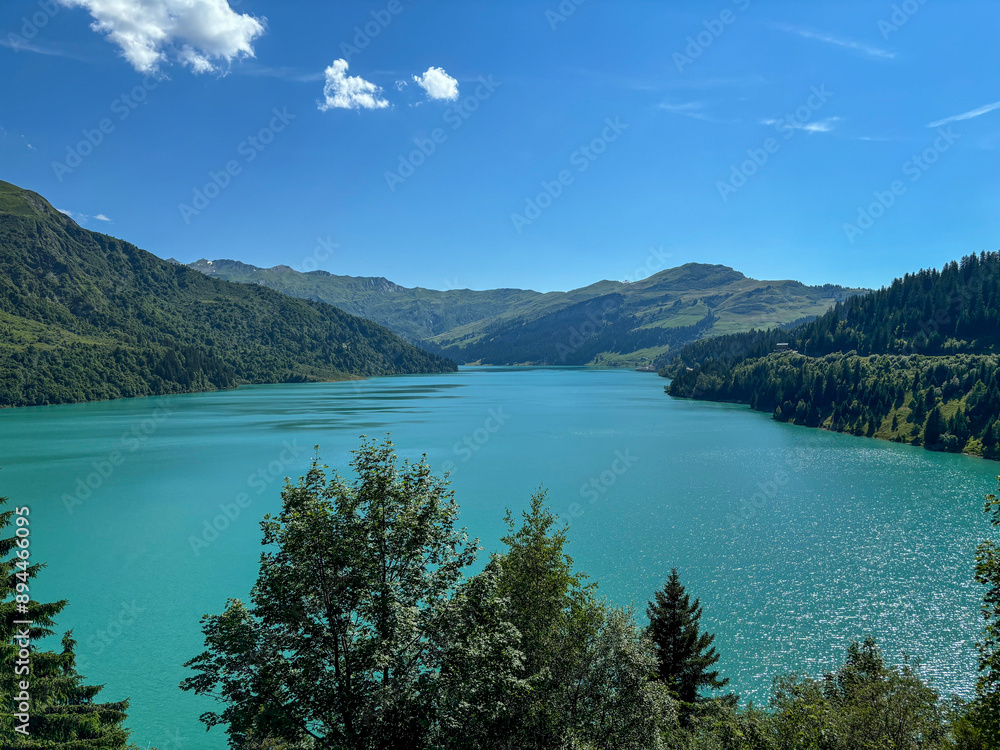 Naklejka premium Beautiful Lake Roselend with turquoise water, clouds and blue sky