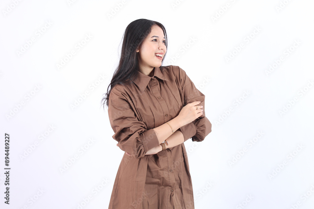 Cheerful Asian woman with confident smile looking at camera wearing brown dress both arms crossed isolated white background Cheerful Asian woman with confident smile looking at camera wearing brown dress both arms crossed isolated white background
