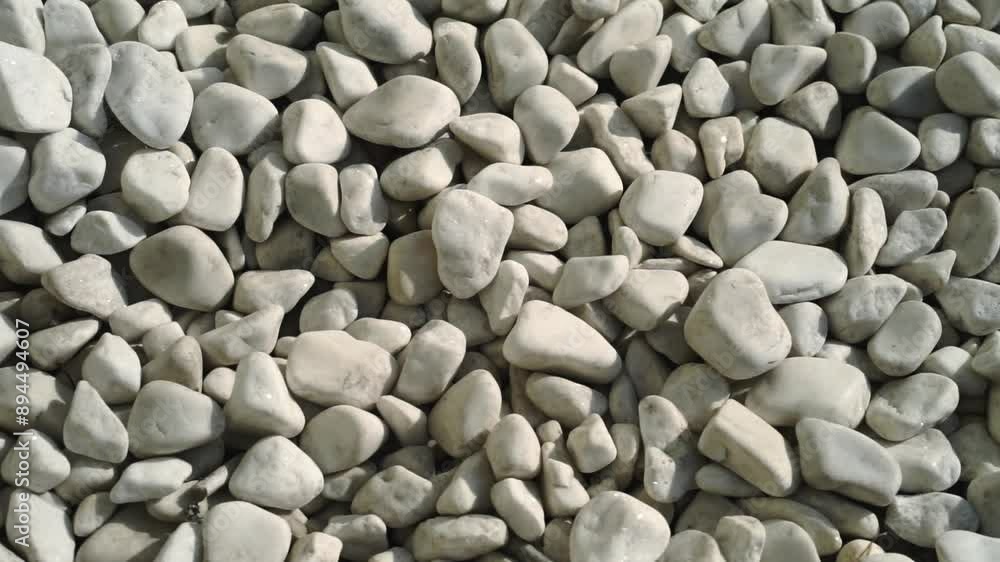 Close-up video of white stones. The pebbles are a light grey-beige ivory color. Pale natural colors, minimal background. Eco-friendly, ecological lifestyle, eco cosmetics advertising concept Close-up video of white stones. The pebbles are a light grey-beige ivory color. Pale natural colors, minimal background. Eco-friendly, ecological lifestyle, eco cosmetics advertising concept