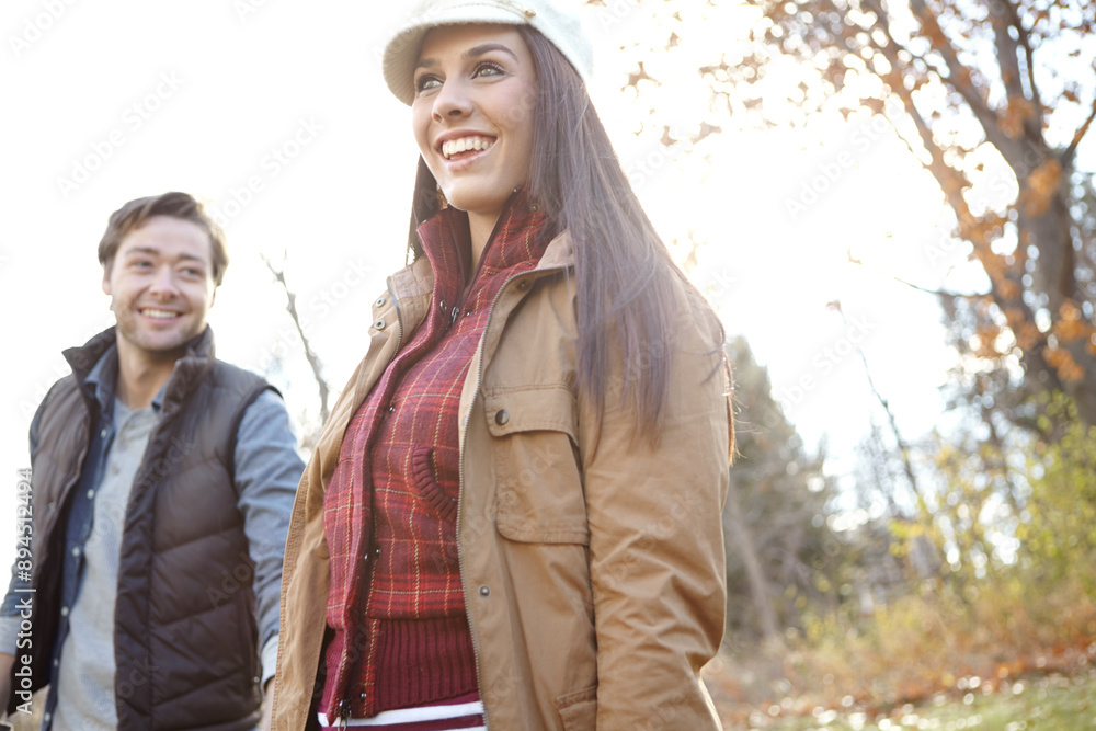 Fototapeta premium Woman, man and walk with nature for park trip, bonding or travel in winter countryside. Smile, love and happy couple in holding hands for morning holiday, vacation or woods picnic or hiking adventure