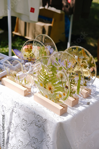 Lamps are made of epoxy resin with dry flowers inside. Handmade work. Market is in the park photo