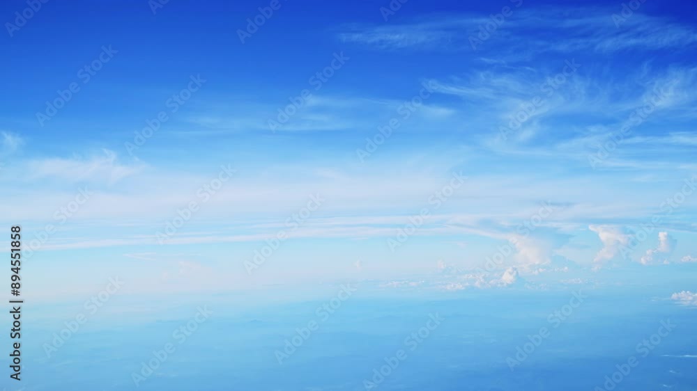 Aerial view of white clouds, from airplane window with blue sky Aerial view of white clouds, from airplane window with blue sky
