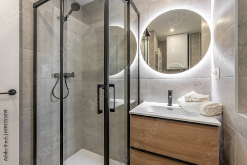 Wallpaper Mural A modern bathroom with a glass shower and backlit mirror for a sleek and elegant look Torontodigital.ca