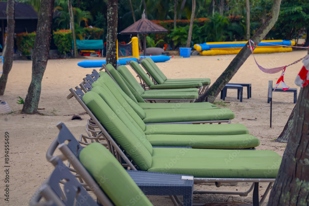 Resting beach bed (high resolution photos) with green cushions at Sentosa beach, Singapore. No people as the beach is closed to public owing to an oil spilage. Resting beach bed (high resolution photos) with green cushions at Sentosa beach, Singapore. No people as the beach is closed to public owing to an oil spilage.