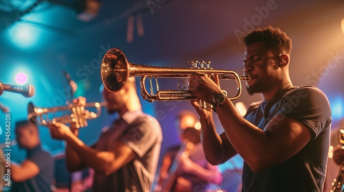 A telephoto angle photo of the jazz band's brass section, with trumpet and trombone players in synchrony, highlighted by stage lights with the club ambiance behind them, with copy photo