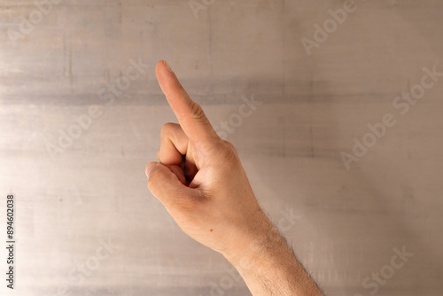 A hand points upwards with ...