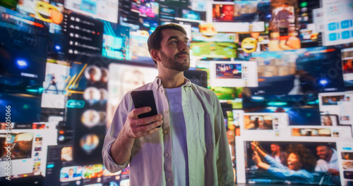 Portrait of Caucasian Man Using Smartphone in Metaverse With Animated Stream Of Interfaces With Social Media, e-Commerce Shopping, Internet Influencers And Games. Visualization Of Web Network.